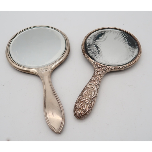 384 - A three piece silver dressing set, Birmingham marks, cast with scrolling foliate mask decoration, an... 