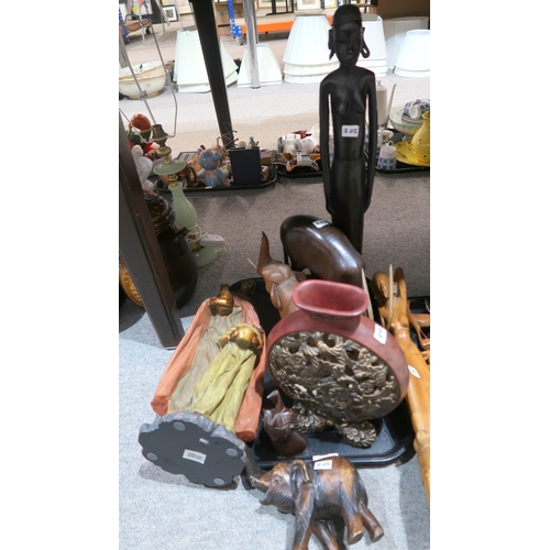 202 - A collection of African figures in wood and resin, brown glazed pottery etc