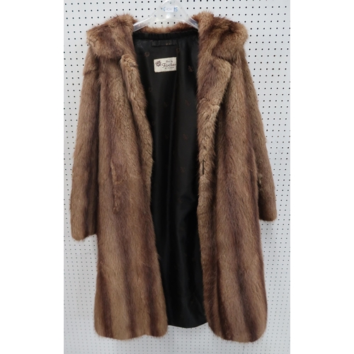 209 - A pale grey fur coat, possibly chinchilla, a long brown fur coat together with a Copland and Lye Ltd... 