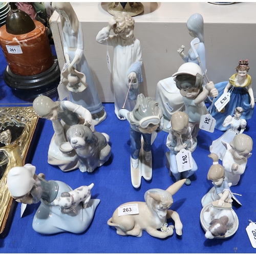 263 - A large collection of figures including Nao, Lladro, Royal Doulton and Coalport