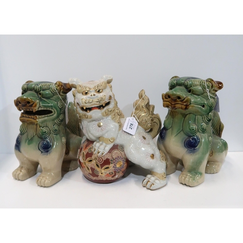 278 - A pair of Chinese Sancai glazed fo dogs, and another white ground gilt decorated example (3)