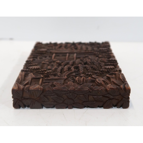 282 - A Chinese carved hardwood case, decorated with figures amongst pavilions, 11.5 x 8cm