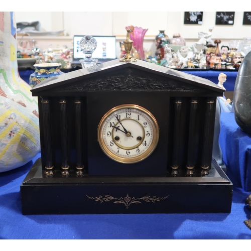 285 - A slate mantel clock with column decorated front and portico frieze