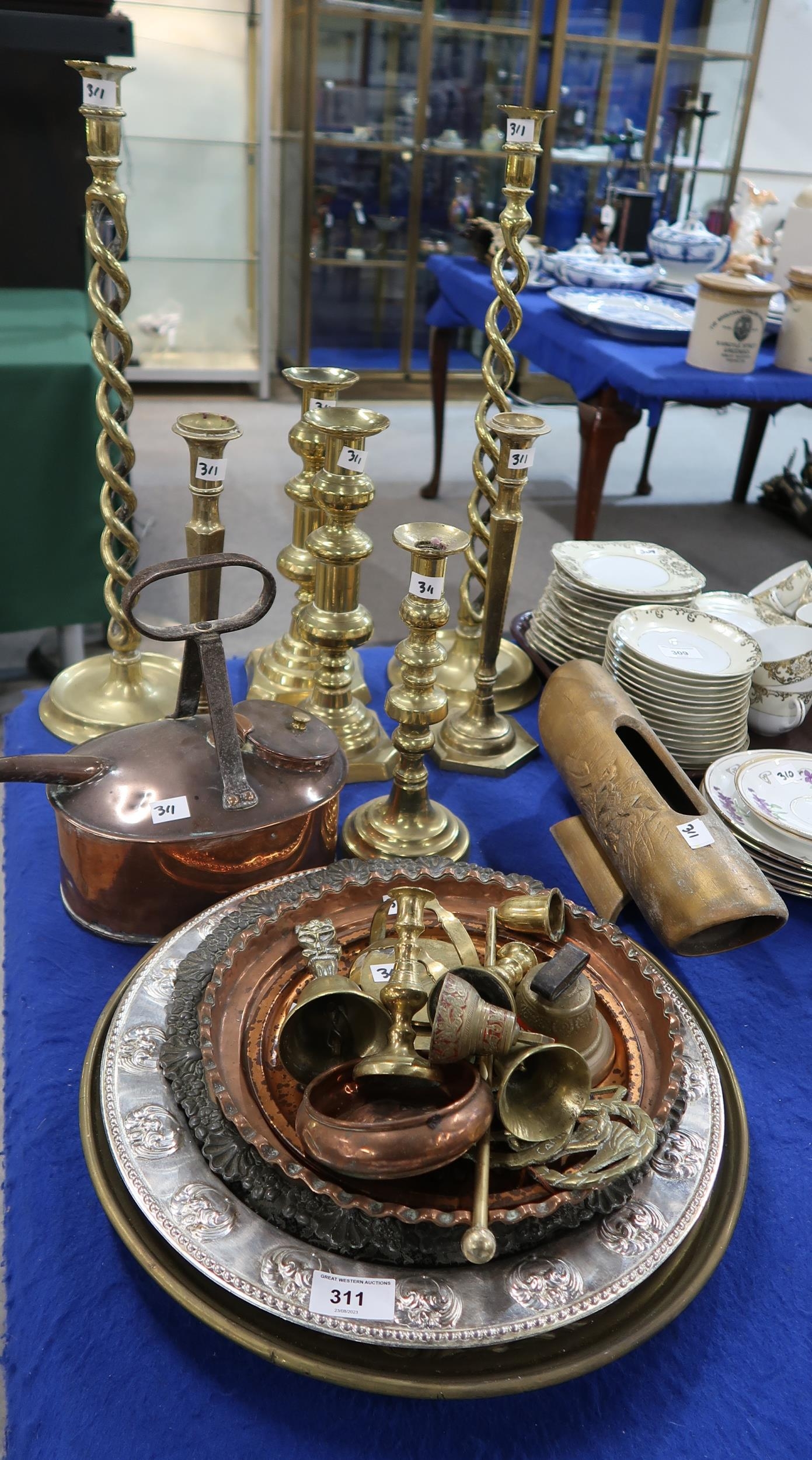 A pair of tall brass barley twist candlesticks, other candlesticks