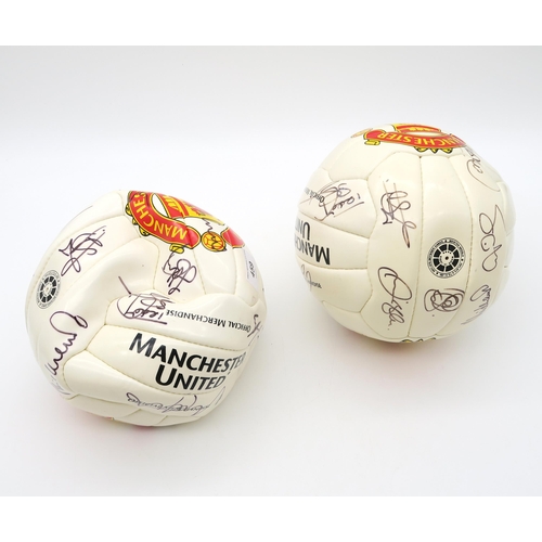 459 - Manchester United: Two footballs, each bearing team signatures, circa-2000s
