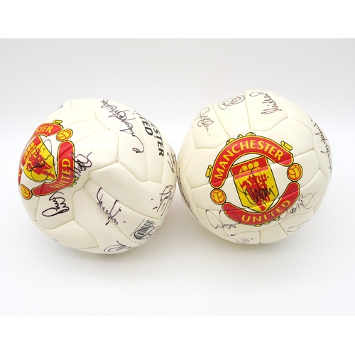 459 - Manchester United: Two footballs, each bearing team signatures, circa-2000s
