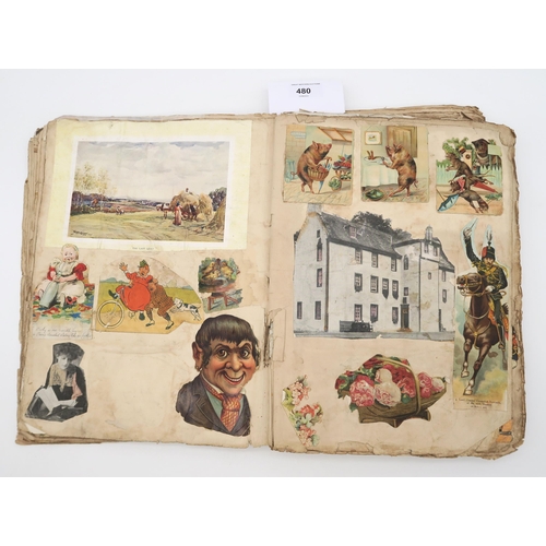 480 - A scrap book, circa 1910, with varied contents to include royalty, seaside postcards, cartoons, phot... 