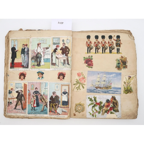 480 - A scrap book, circa 1910, with varied contents to include royalty, seaside postcards, cartoons, phot... 