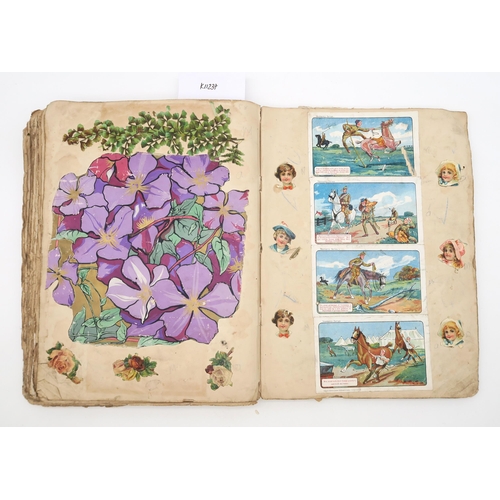 480 - A scrap book, circa 1910, with varied contents to include royalty, seaside postcards, cartoons, phot... 