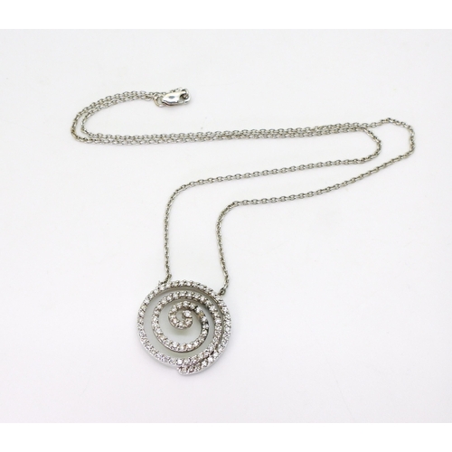 765 - A white metal spiral pendant necklace stamped 750 and set with estimated approx 0.90cts of brilliant... 