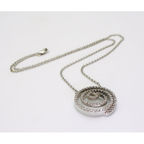 765 - A white metal spiral pendant necklace stamped 750 and set with estimated approx 0.90cts of brilliant... 