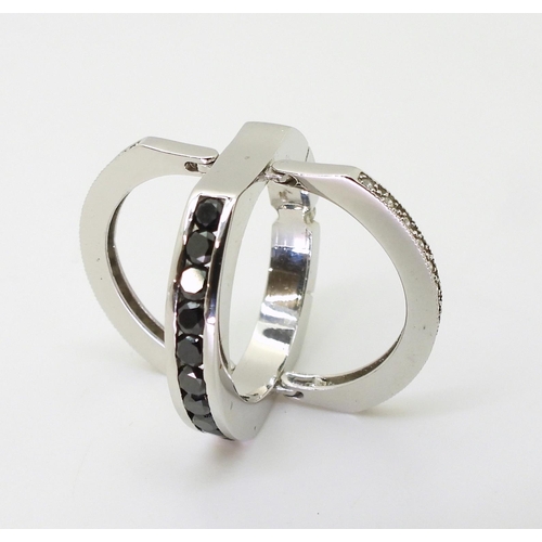 768 - A 14k white gold night & Day ring set with an estimated approx 0.99cts of black & white diam... 