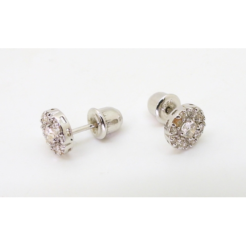 770 - a pair of 18ct white gold diamond cluster earrings set with estimated approx 0.50cts across the pair... 