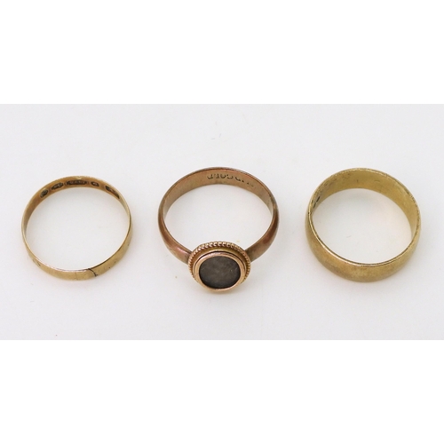 778 - Two 9ct gold wedding bands, size P, and size P 1/2, with a further yellow metal ring with a hair pan... 