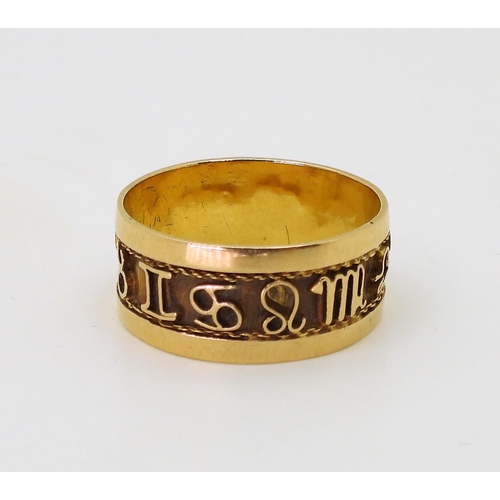 779 - A bright yellow metal band ring, decorated with zodiac signs details, size Q1/2, weight 3.5gms