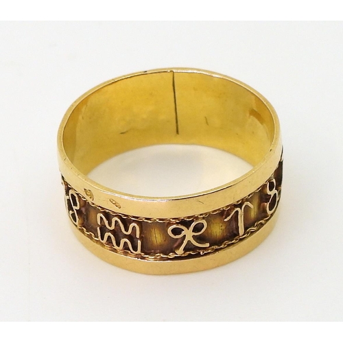 779 - A bright yellow metal band ring, decorated with zodiac signs details, size Q1/2, weight 3.5gms