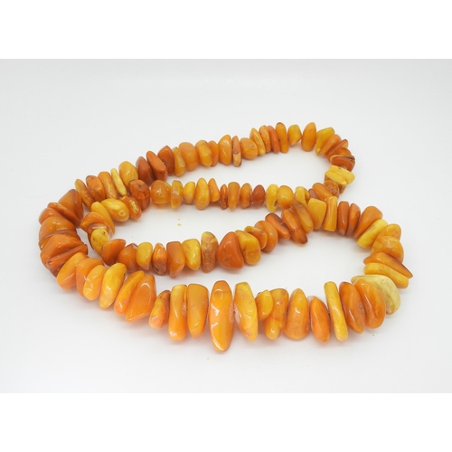 798 - A long string of large amber chip beads, tapering in size from approx 4cm to 2cm, approx length 90cm... 