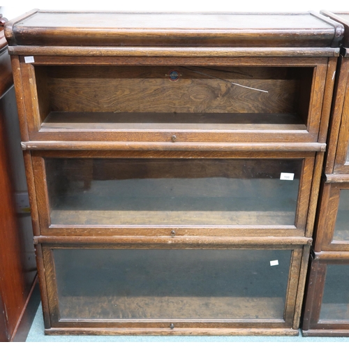 100 - An early 20th century Globe Wernicke three tier sectional bookcase with glazed fall front doors (one... 