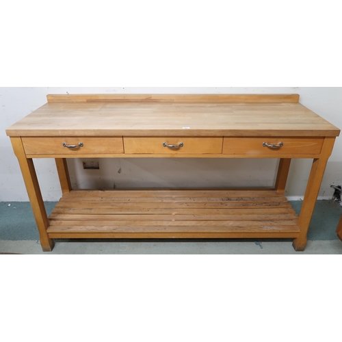 107 - A contemporary pine kitchen work table with three drawers on chamfered square supports joined by sla... 