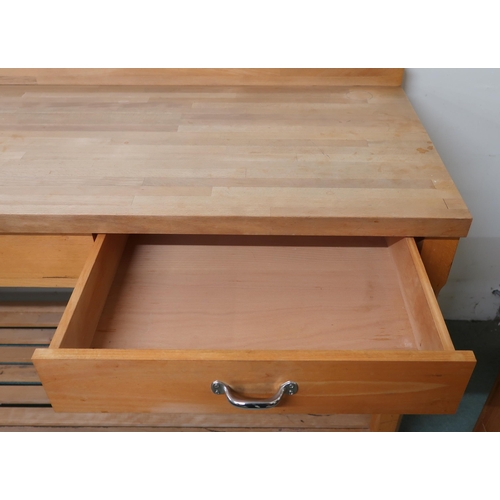 107 - A contemporary pine kitchen work table with three drawers on chamfered square supports joined by sla... 