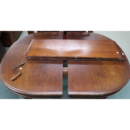 119 - A Victorian mahogany oval wind out extending dining table with two spare leaves on turned supports, ... 