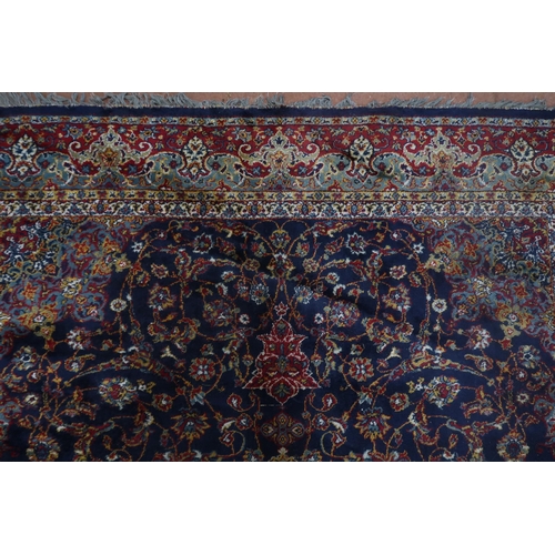 122 - A blue ground Tabriz rug with central sun burst medallion on floral patterned ground with light blue... 