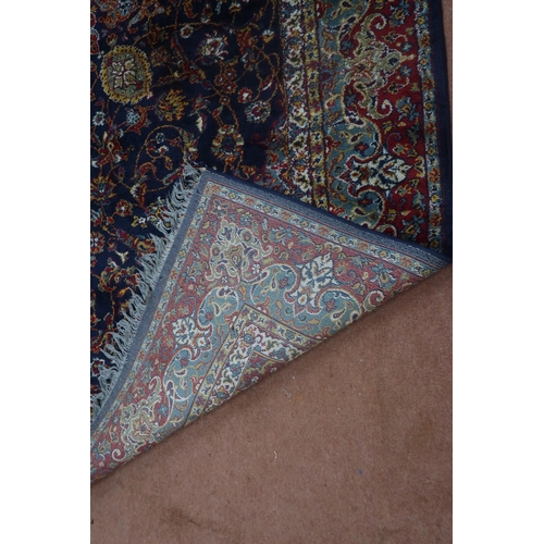 122 - A blue ground Tabriz rug with central sun burst medallion on floral patterned ground with light blue... 