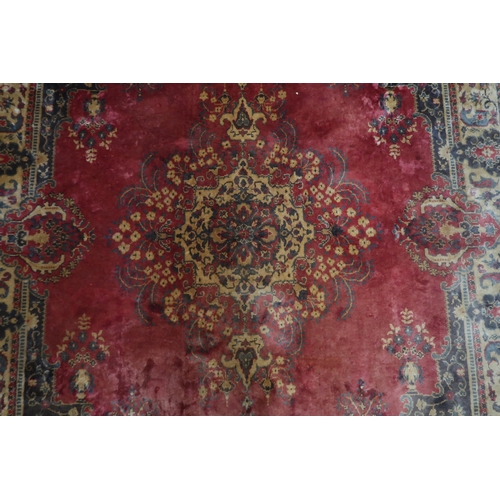 123 - A red ground Keshan rug with cream central medallion, matching spandrels and borders, 353cm long x 2... 