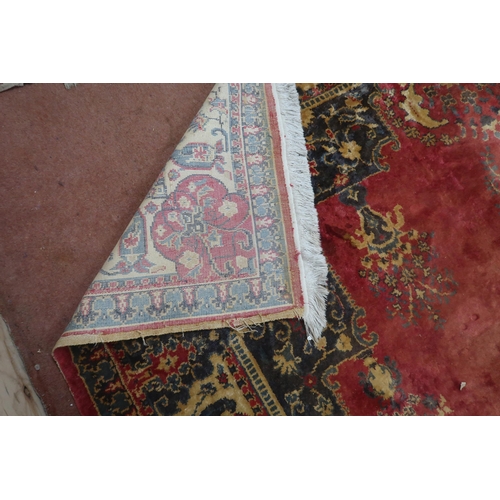 123 - A red ground Keshan rug with cream central medallion, matching spandrels and borders, 353cm long x 2... 