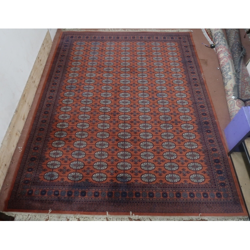 124 - A pair of terracotta ground Bokhara rugs with all over lozenge design and multicoloured border, 364c... 