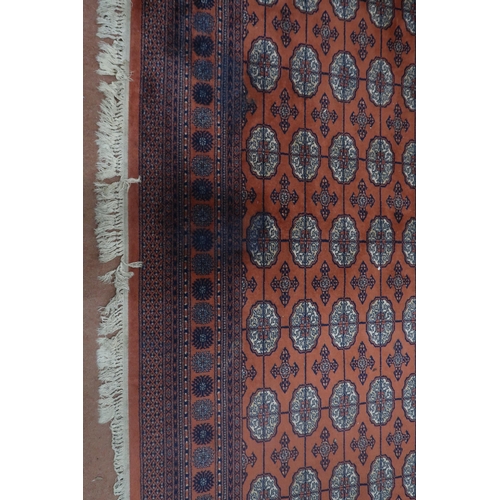 124 - A pair of terracotta ground Bokhara rugs with all over lozenge design and multicoloured border, 364c... 