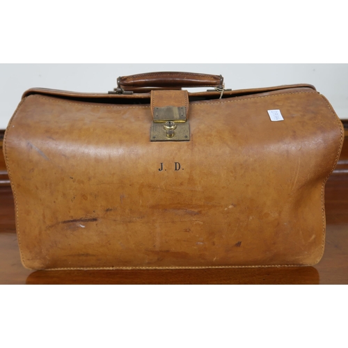 125 - A pair of 20th century metal bound travel trunks and a leather Gladstone style bag containing lawn b... 