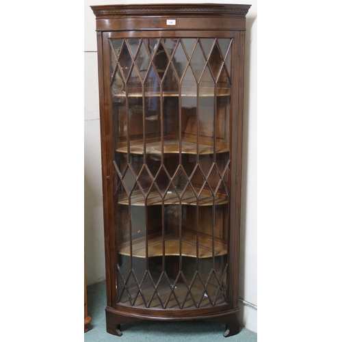 138 - A 20th century mahogany astragal glazed bow front corner cabinet, 167cm high x 75cm wide x 53cm deep