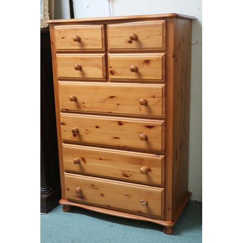 139 - A contemporary pine chest of drawers with four short over four long drawers on turned feet, 123cm hi... 