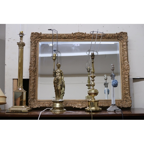 140 - A lot comprising contemporary gilt framed bevelled glass wall mirror, two assorted brass standard la... 