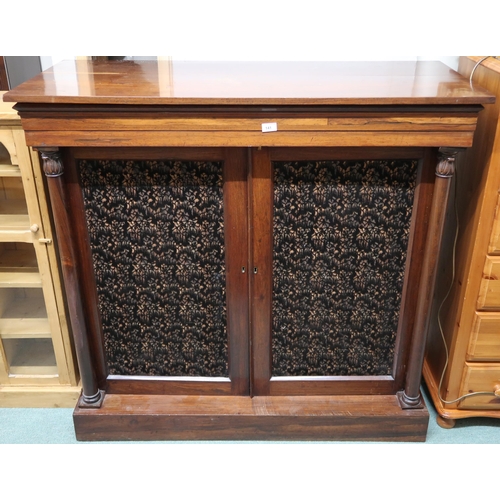 141 - A Victorian rosewood side cabinet with pair of upholstered panel doors flanked by turned columns on ... 