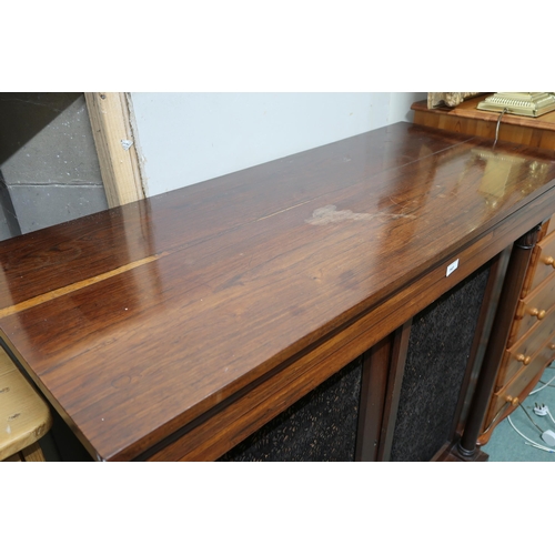 141 - A Victorian rosewood side cabinet with pair of upholstered panel doors flanked by turned columns on ... 