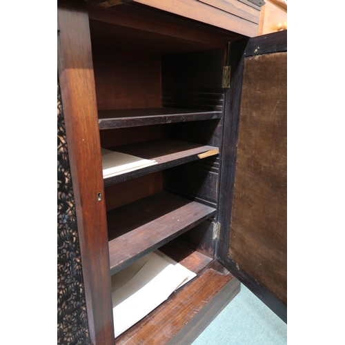 141 - A Victorian rosewood side cabinet with pair of upholstered panel doors flanked by turned columns on ... 