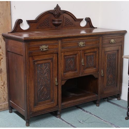 154 - A Victorian oak sideboard with three short drawers over pair of cabinet doors flanked by cabinet doo... 