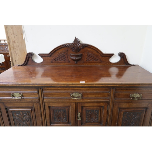 154 - A Victorian oak sideboard with three short drawers over pair of cabinet doors flanked by cabinet doo... 