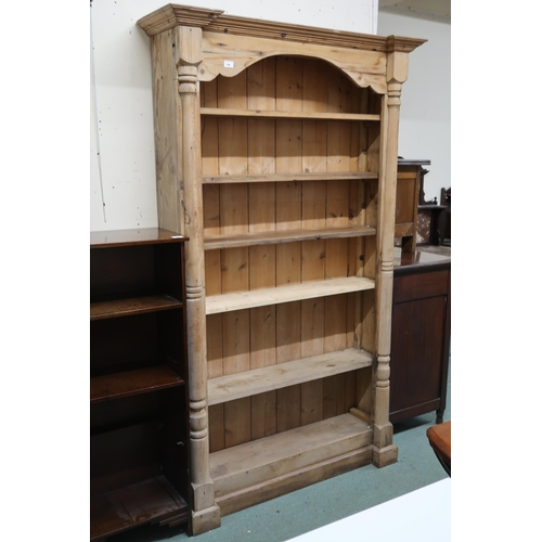 156 - A 20th century pine open bookcase with moulded cornice over five adjustable shelves flanked column r... 