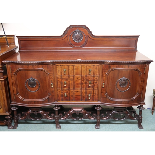 162 - A large 20th century mahogany sideboard with three central drawers flanked by cabinet doors on carve... 