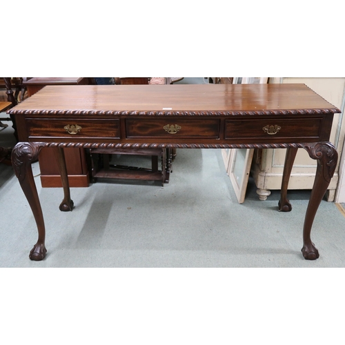 166 - A 20th century mahogany console table with rectangular top with gadrooned edges over three drawers o... 