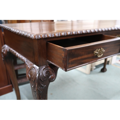 166 - A 20th century mahogany console table with rectangular top with gadrooned edges over three drawers o... 