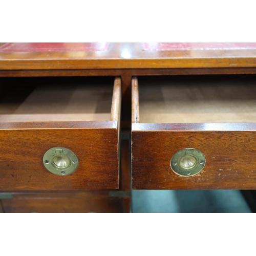 26 - A 20th century campaign style pedestal writing desk with embossed skiver over three drawers on three... 