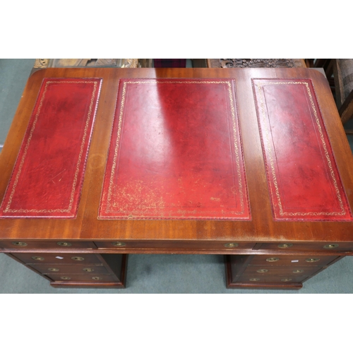 26 - A 20th century campaign style pedestal writing desk with embossed skiver over three drawers on three... 