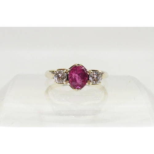 2841 - A PINK SAPPHIRE AND DIAMOND RINGmounted in white metal with decorative crown mounts, the two diamond... 