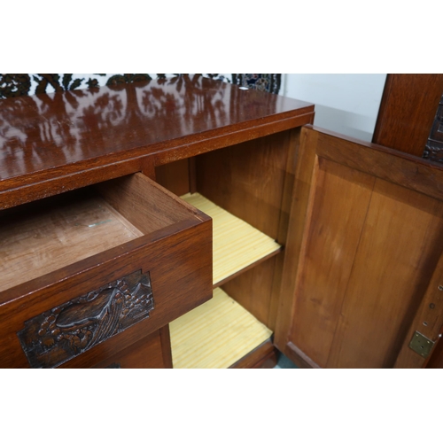 38 - A 20th century Oriental hardwood sideboard with four central drawers flanked by cabinet doors on pli... 