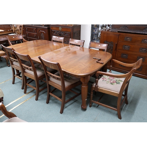 43 - A Victorian wind out extending dining table and eight sabre legged dining chairs, table with two spa... 