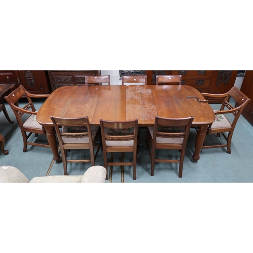 43 - A Victorian wind out extending dining table and eight sabre legged dining chairs, table with two spa... 